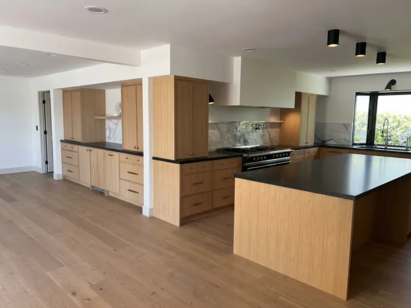 Open-plan white oak kitchen with a large island